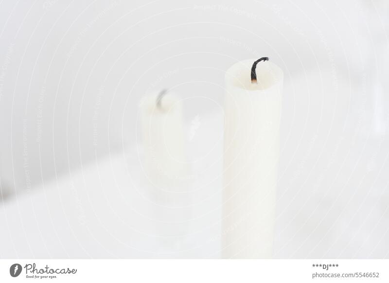 Two white staggered candles whose flame is no longer burning shoulder stand Candlewick Wick Hope Moody Wax Decoration Burn symbol from Grief Light blurriness