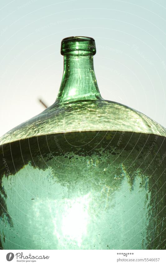 A green large glass jar or carafe filled with water receptacle Bottle of water Glass Water Perspective Green Carafe Beverage Drinking water Fresh Thirst Fluid