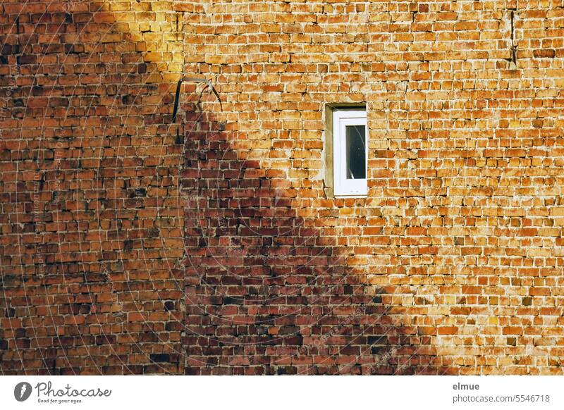 old building made of unplastered bricks with a small window and half in the shade Unplastered Window Brick construction Red Shadow Old Old building dwell
