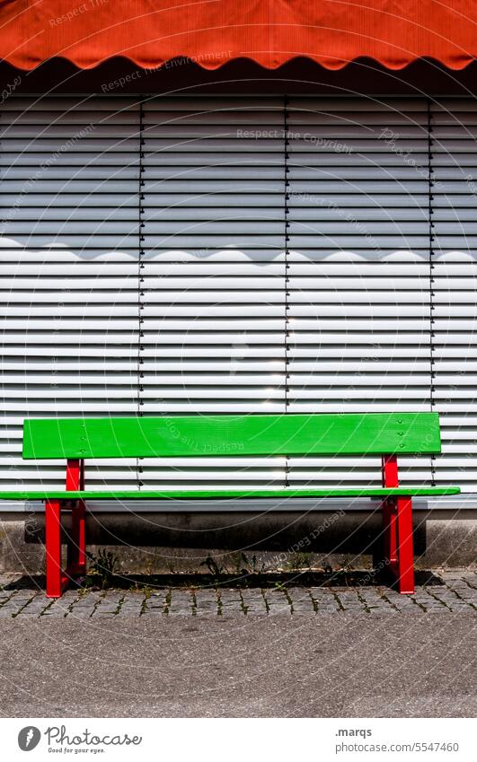 Red-green bench Closed Roller shutter Bench Relaxation Empty Colour Sunday Sun blind Break Pedestrian precinct Summer Calm Green Wooden bench