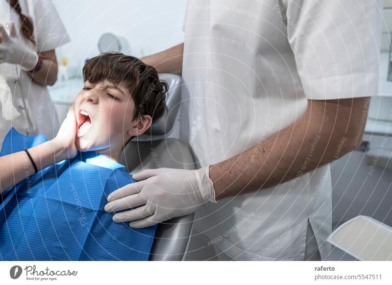 little boy with teeth pain looking sadness on his dentist dentistry patient person toothache clinic dental treatment chair office check-up woman medicals indoor