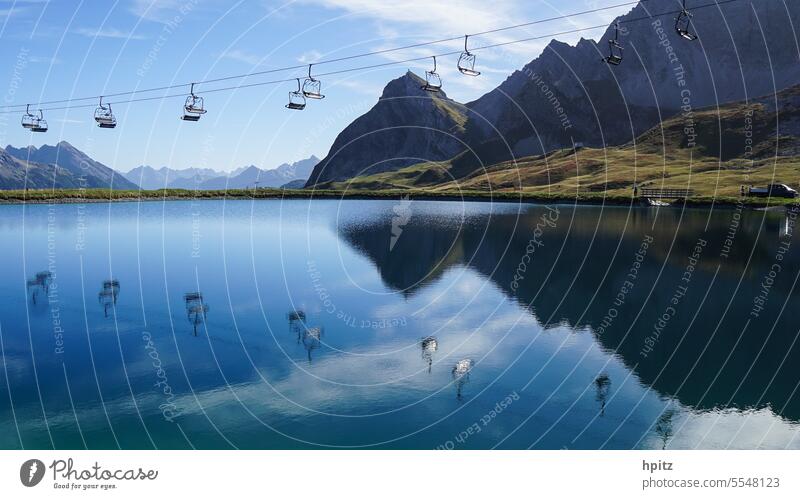 Mountain world with chairlift Mountains in the background chair lift Reflection in the water Landscape Sky Lake
