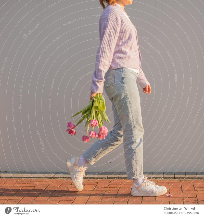 tulips Young woman Walking Spirited blossom portrait Spring Bouquet Tulip blossom Light and shadow flowers pretty pastel shades Blossoming light colours