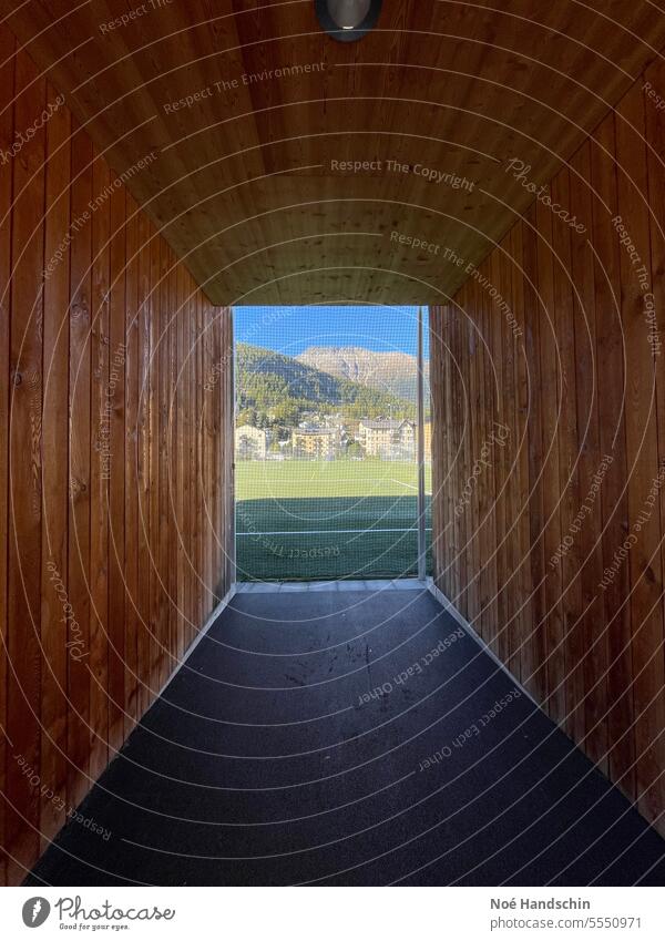 View through the wooden tunnel Engadine Wood Tunnel mountains Football pitch Mountain Nature Switzerland Exterior shot Sky Colour photo Deserted Day Wide angle