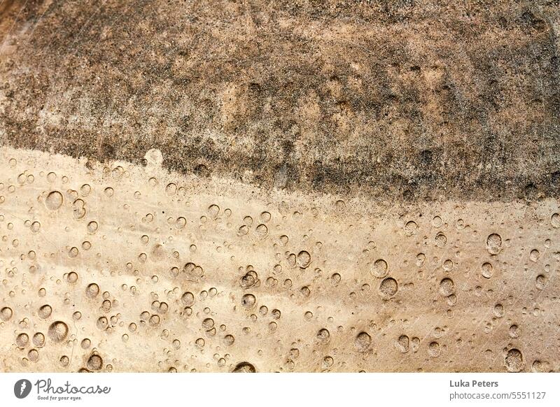 A color split shot of wet sand with air bubbles, brown and bronze. Structures and shapes Abstract structures Nature naturally background Sand Brown