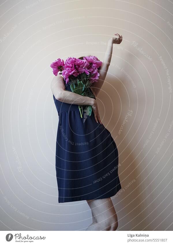 Young woman holding a bouquet of flowers Bouquet Flower Nature Blossoming Decoration peonies Peony celebration Woman Girl obscured face Anonymous Birthday