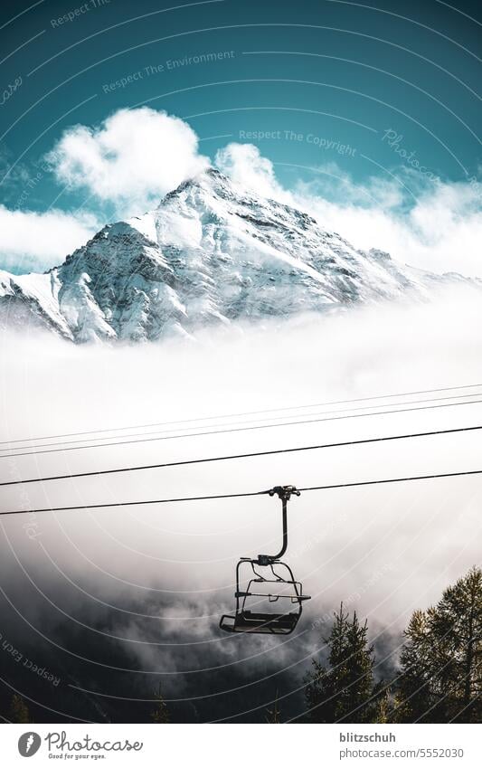 Chairlift with Lenzerhorn 2906m in the background chair lift Mountain Nature Tourism Landscape Vacation & Travel Snow Alps Clouds Rock mountains Peak
