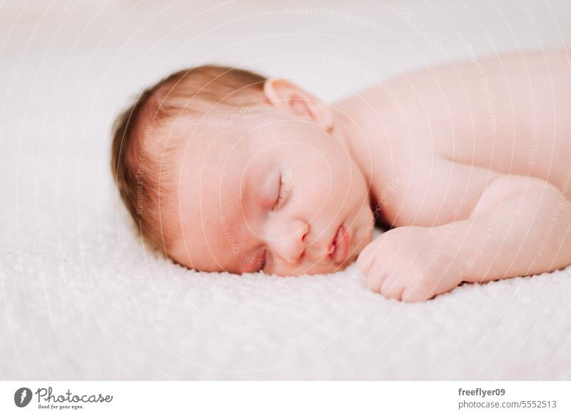 portrait of a newborn asleep in studio lighting baby firstborn laying laying down copy space parenthood motherhood innocence life labor young boy happy small