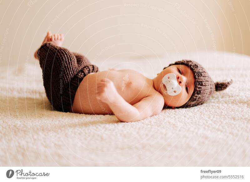 portrait of a newborn in a costume in studio lighting baby firstborn laying laying down copy space parenthood motherhood innocence life labor young boy happy