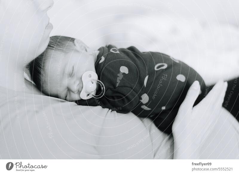 A newborn baby asleep on his mothers chest firstborn portrait laying laying down copy space parenthood motherhood innocence life labor young boy happy small