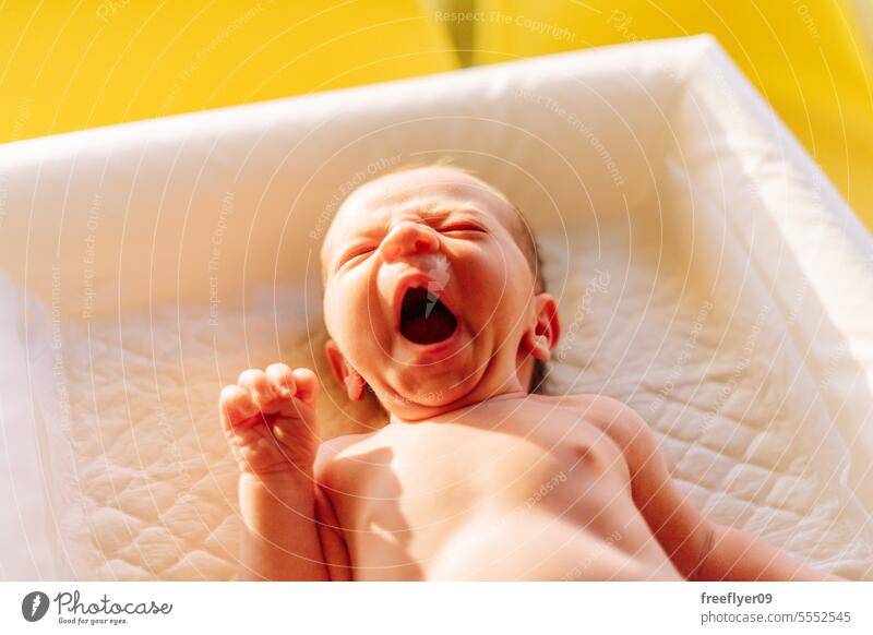 Portrait of a newborn yawning on a baby changer sleepy copy space parenthood motherhood innocence life labor young boy happy small pregnancy little childhood