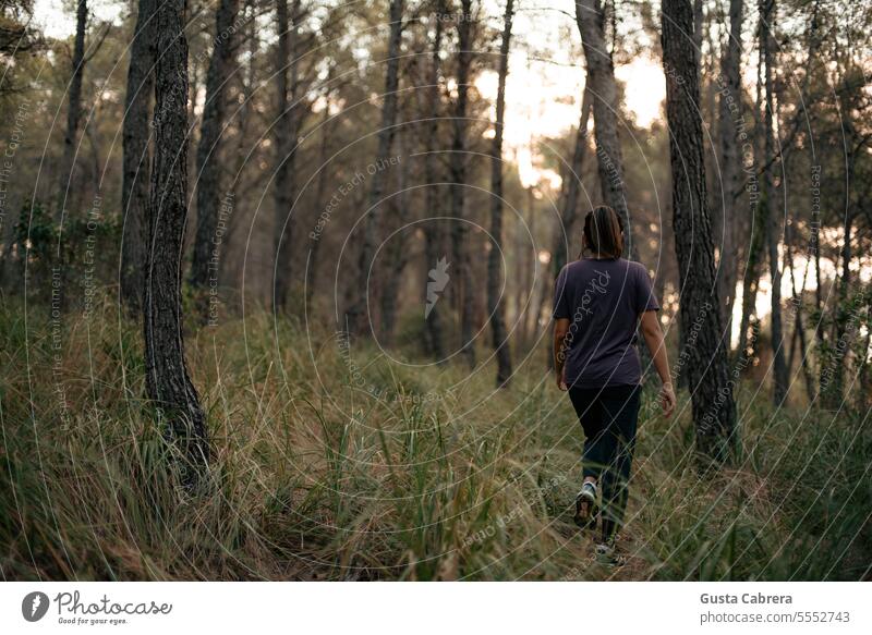 Woman walking in the forest. Walking Forest female nature lifestyle outdoors enjoy activity relax freedom park Landscape Trees