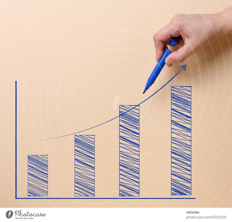 A graph drawn with a felt-tip pen with growing indicators on a beige background. drawing hand finance arrow market economic profit business concept success