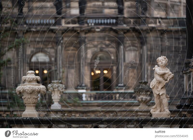 baroque angel with other decorative elements in front of an old castle Baroque Putt Angel Scultpture Zwinger Lock Shallow depth of field Historic Monument