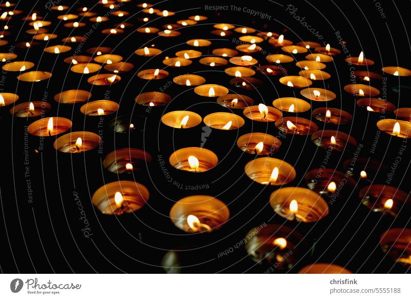 Tea lights in dark room shoulder stand Light clearer Church Prayer Hope Religion and faith Belief Christianity religion Candlelight Spirituality Death Grief