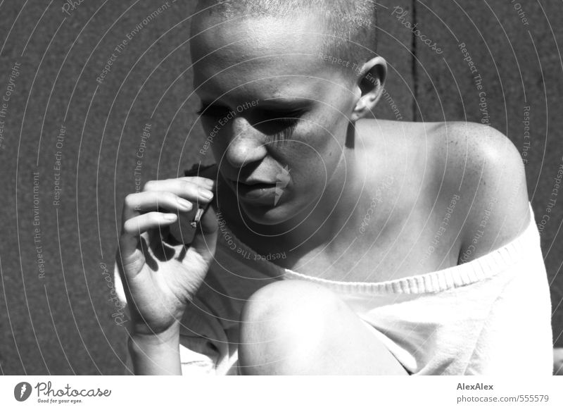 Young woman with very short hair smokes a cigarette Smoking Intoxicant Youth (Young adults) Head Shoulder by hand Knee Freckles 18 - 30 years Adults
