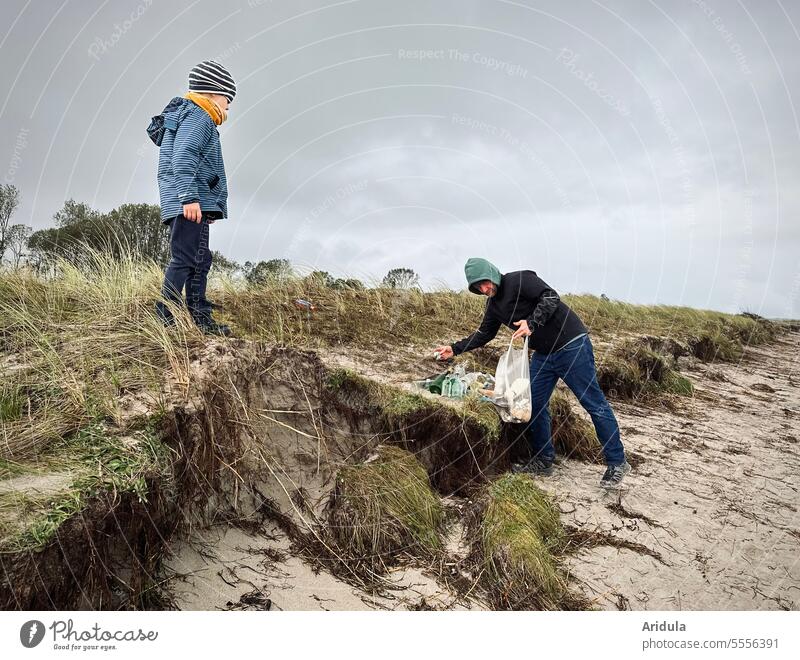 Two hardworking garbage collectors on the Baltic Sea beach Trash amass soiling Environment waste ecology Recycling Disposal Plastic Environmental pollution