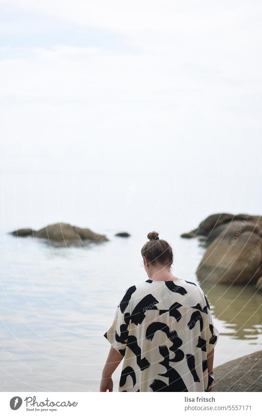 HAZY - BY THE SEA - DISCOVER Woman 30-40 years back view Chignon Water Ocean Rock Adults Colour photo Exterior shot hazy Discover Vacation & Travel tranquillity