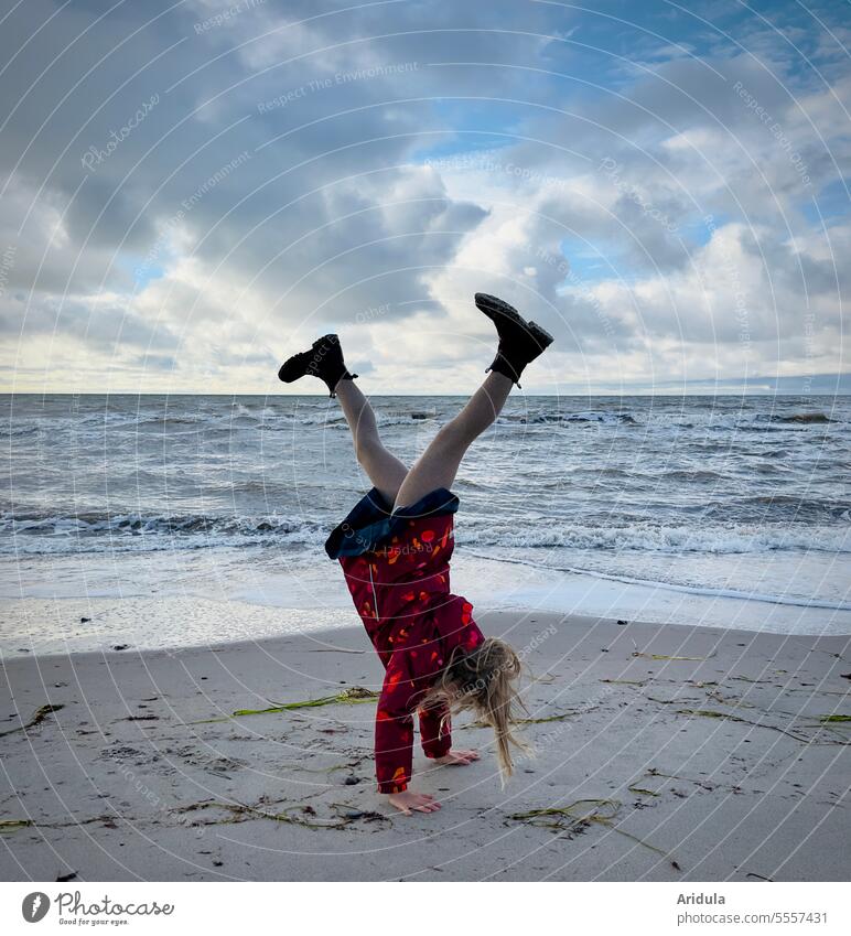 Child doing handstand on beach Handstand Beach Movement Sports Athletic Joie de vivre (Vitality) Sand Ocean overhead Sky Joy Human being Playing Infancy