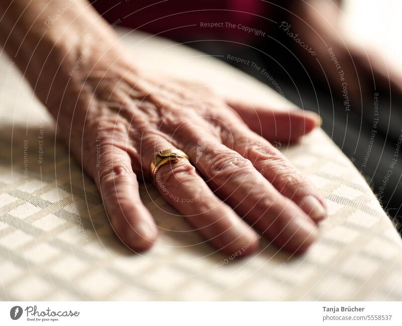 Old woman hand with golden wedding ring Old Hand gold wedding ring Wedding band everlasting love Love beyond death crease wrinkled age Earmarked Until death
