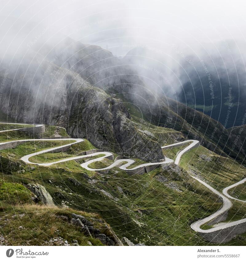 Serpentines of the old road over the Gotthard Pass in the Swiss Alps pass road mountain road Gotthard pass mountain pass Switzerland Fog Winding road Ticino