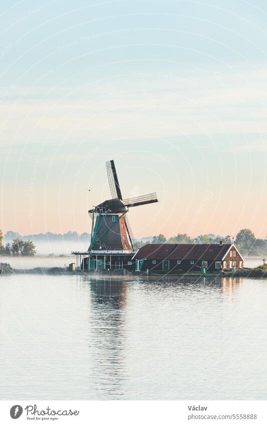 Popular tourist spot Zaanse Schans is near Amsterdam in the west of the Netherlands. Historical, realistic windmills during sunrise. Holland's landmark