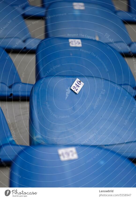 Empty blue seats in a football stadium arena audience chair empty event in a row no people nobody plastic chair plastic seat Row of seats Seating