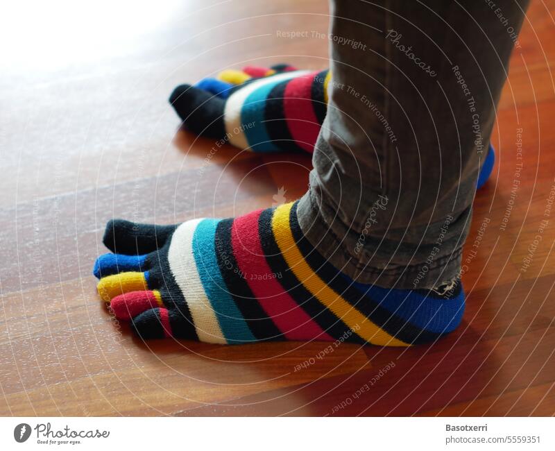 Colorful socks (toe socks) on children's or women's feet variegated Child Woman Children's Feet Women's Feet cheerful Congenial Childish at home Interior shot