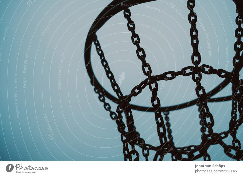 Metal basketball hoop silhouette against the sky Basketball basket Steel chains Iron chain Black somber Sports free time Beach Silhouette Sky Blue Ball sports