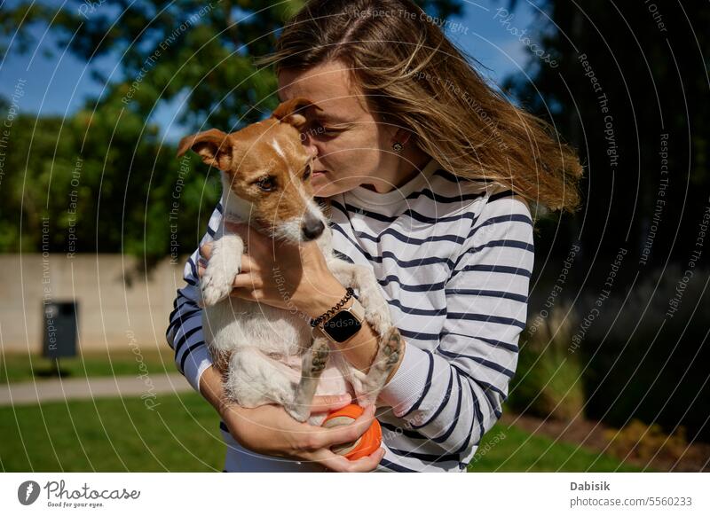 Woman hugging and kissing her dog pet woman love emotion together petting embracing cute hold care friend positive friendship enjoyment owner people animal