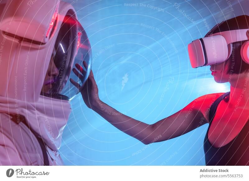 Anonymous astronaut in spacesuit and woman wearing VR goggles vr goggles cosmonaut spaceman explore spacewoman headphones mission specialist astronomy planet
