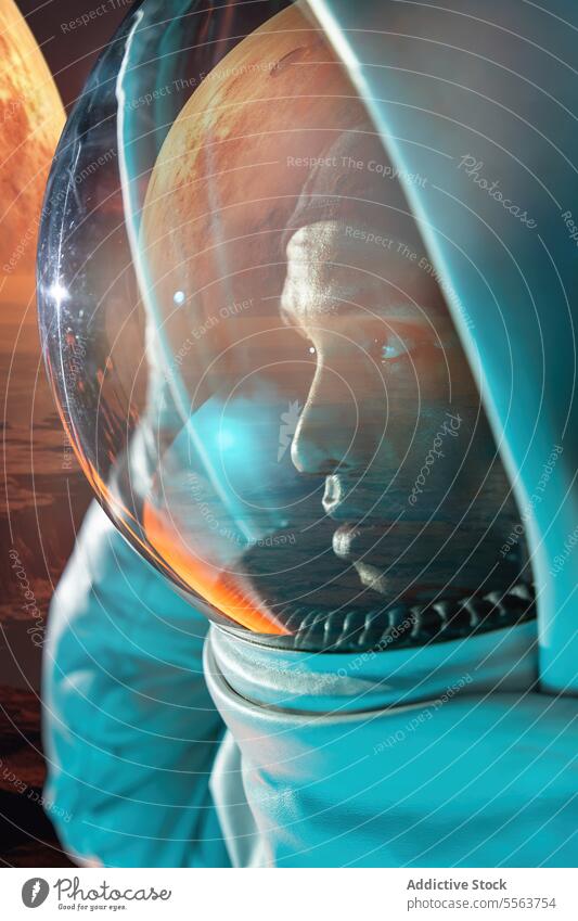 Male ethnic astronaut in spacesuit looking through glass helmet cosmonaut explore galaxy mission specialist astronomy planet project man standing costume