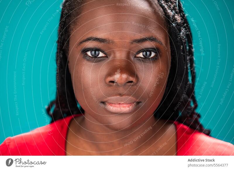 African woman close-up portrait african face detail feature eye skin texture background turquoise beauty expression emotion look gaze eyebrow lip complexion