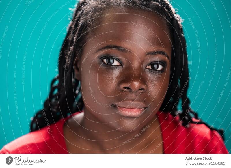 Detailed gaze of African woman against teal background close-up african eyes makeup turquoise beauty expression detail look emotion portrait face skin eyeliner