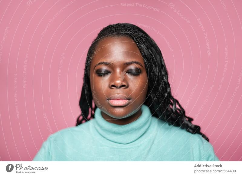 Portrait of African woman with closed eyes african portrait pink background serene makeup face beauty elegance style fashion skin glow youth female confidence