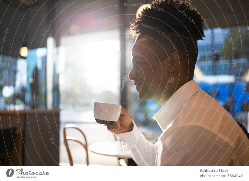 Headshot of black man drinking hot beverage credit card smile coffee cup cafe hot drink pensive happy portrait calm african american male coffee break guy