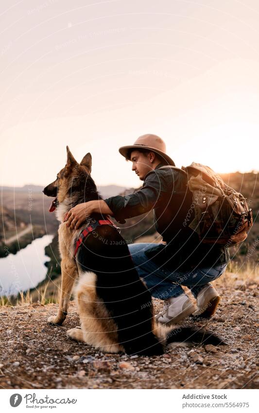 Dog with his owner in the wild man dog training loyal german shepherd treat animal male friend obedient sunny sunlight nature domestic mammal friendship
