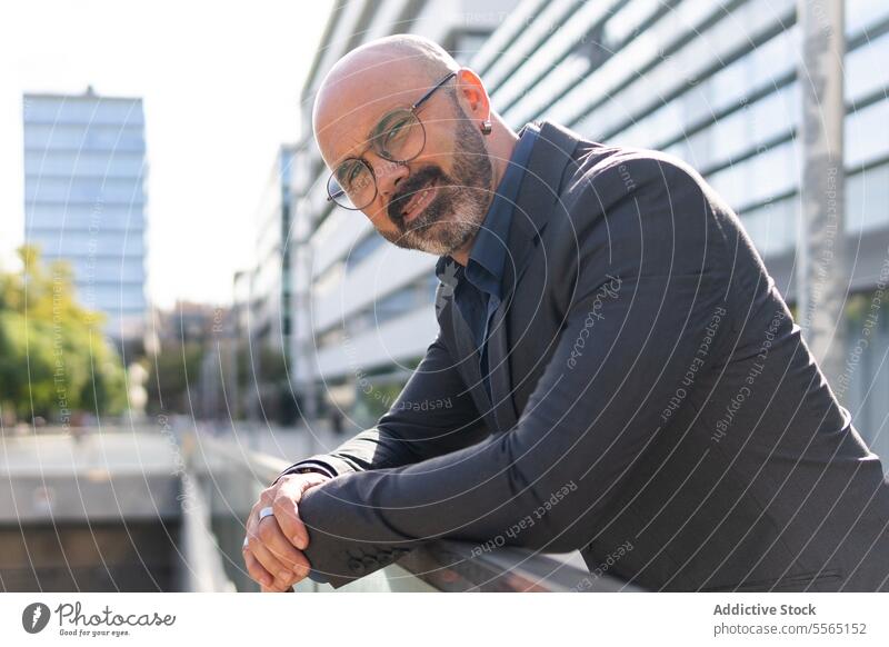 Portrait of a bearded and bald business man on the street person businessman portrait looking male adult city entrepreneur face outdoors horizontal one person