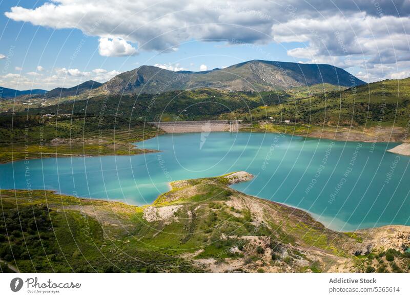 Calm lake surrounded by mountains ridge reservoir landscape pond river water blue flora peaceful scenery valley hill slope green countryside nature rural shore