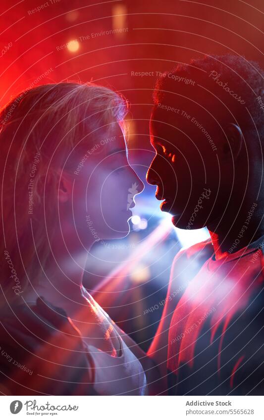Couple in Intense connection in vibrant light couple emotion red close-up face young intensity profile gaze encounter individual african american black color