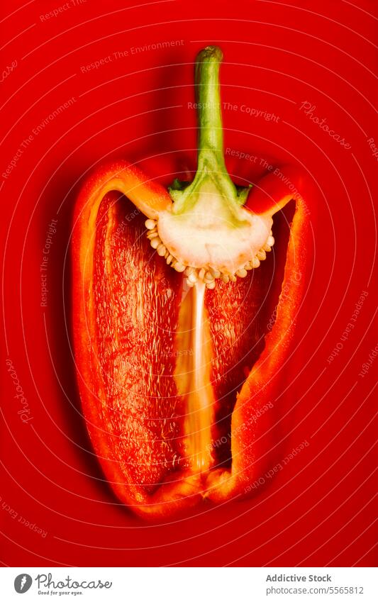 Ripe shiny sliced pepper on red surface vegetable preparation seasonal food organic meal cuisine healthy appetizer vegetarian juicy crunchy fresh delicious