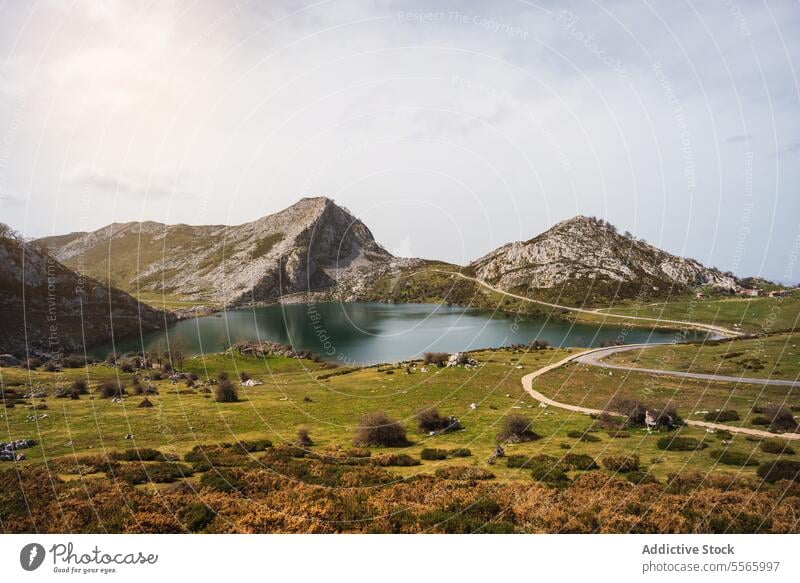 A large body of water surrounded by mountains lake nature landscape covadonga scenic tranquil reflection wilderness outdoors serene peaceful natural beauty