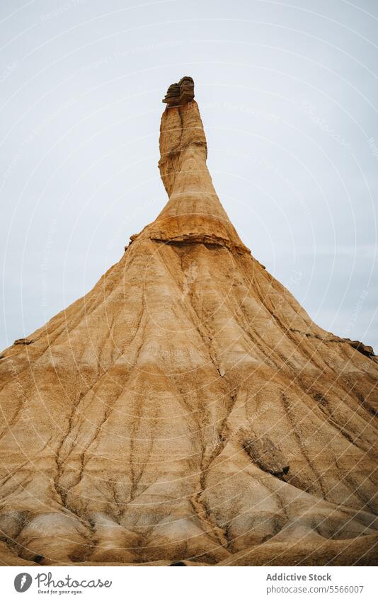 A large rock formation in the middle of a desert bardenas reales navarra arid dry sand dunes mountain landscape geology erosion stone nature wilderness barren