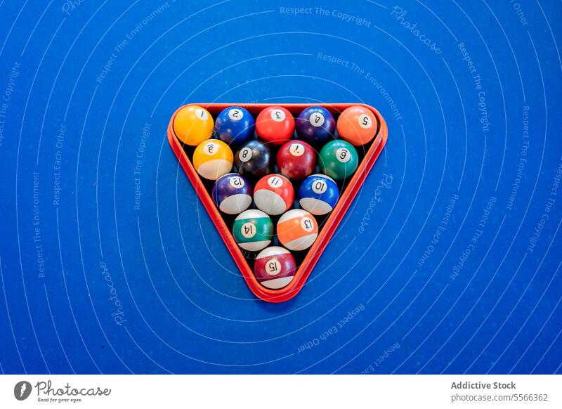 Billiard balls on pool table billiard leisure recreational pyramid pub play indoors game sport snooker colorful different number triangle blue high angle