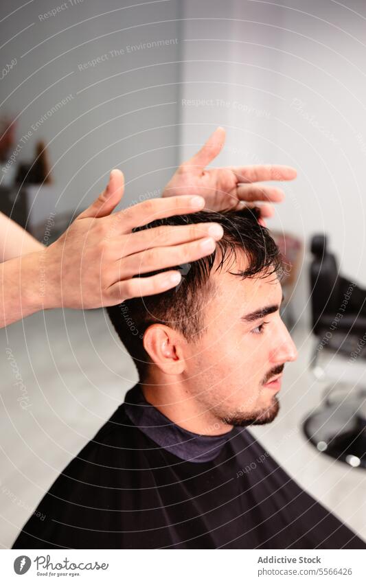 Close-up of barber hands setting client's hair in salon Barber styling man close-up male focus detail care caucasian treatment precision trend skill grooming