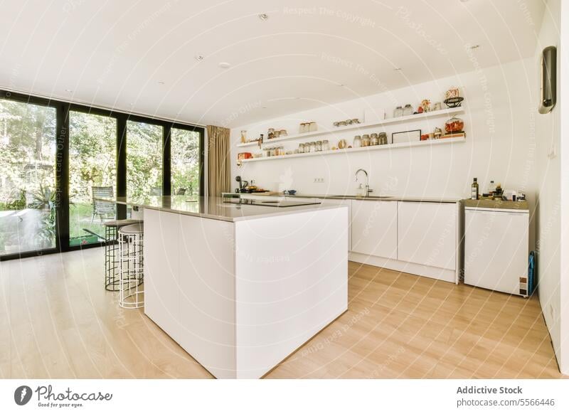 Modern kitchen with white countertop and large window island shelf essential spacious interior cooking modern home induction pantry food organized jar appliance