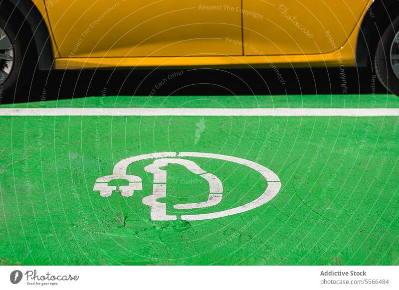 Electric car charger sign on ground electric ecology energy automobile plug symbol automotive recycle power street battery eco friendly transport yellow car