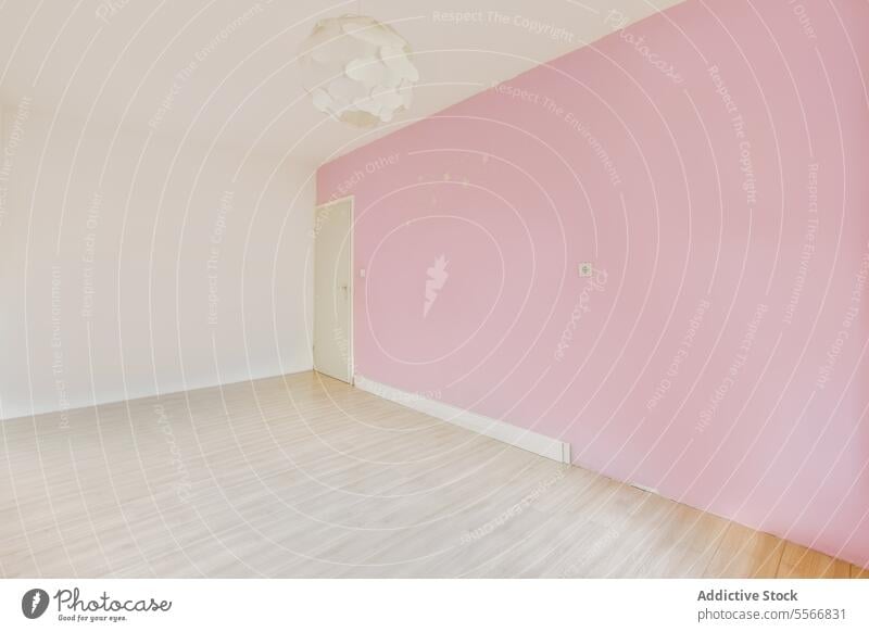 Empty room with pink and white walls empty parquet floor apartment door living room copy space house spacious interior unfurnished home modern new flat