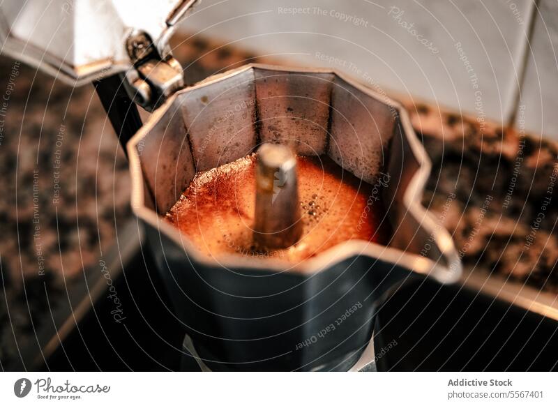 Brewing moment captured coffee brew espresso stovetop maker bubble aroma rich texture close-up metal steam Italian home preparation fresh detail pot spout hinge