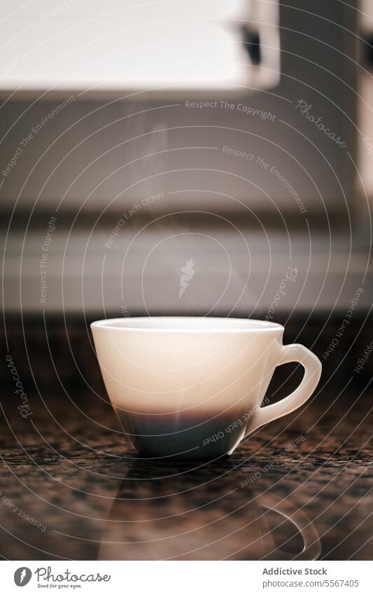 Steamed serenity cup steam coffee white countertop granite light ambient morning calm ritual ceramic handle beverage reflection surface shadow depth focus